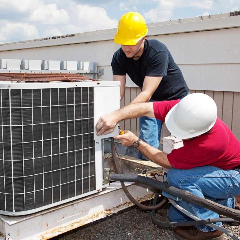 two techs working on commercial AC repair