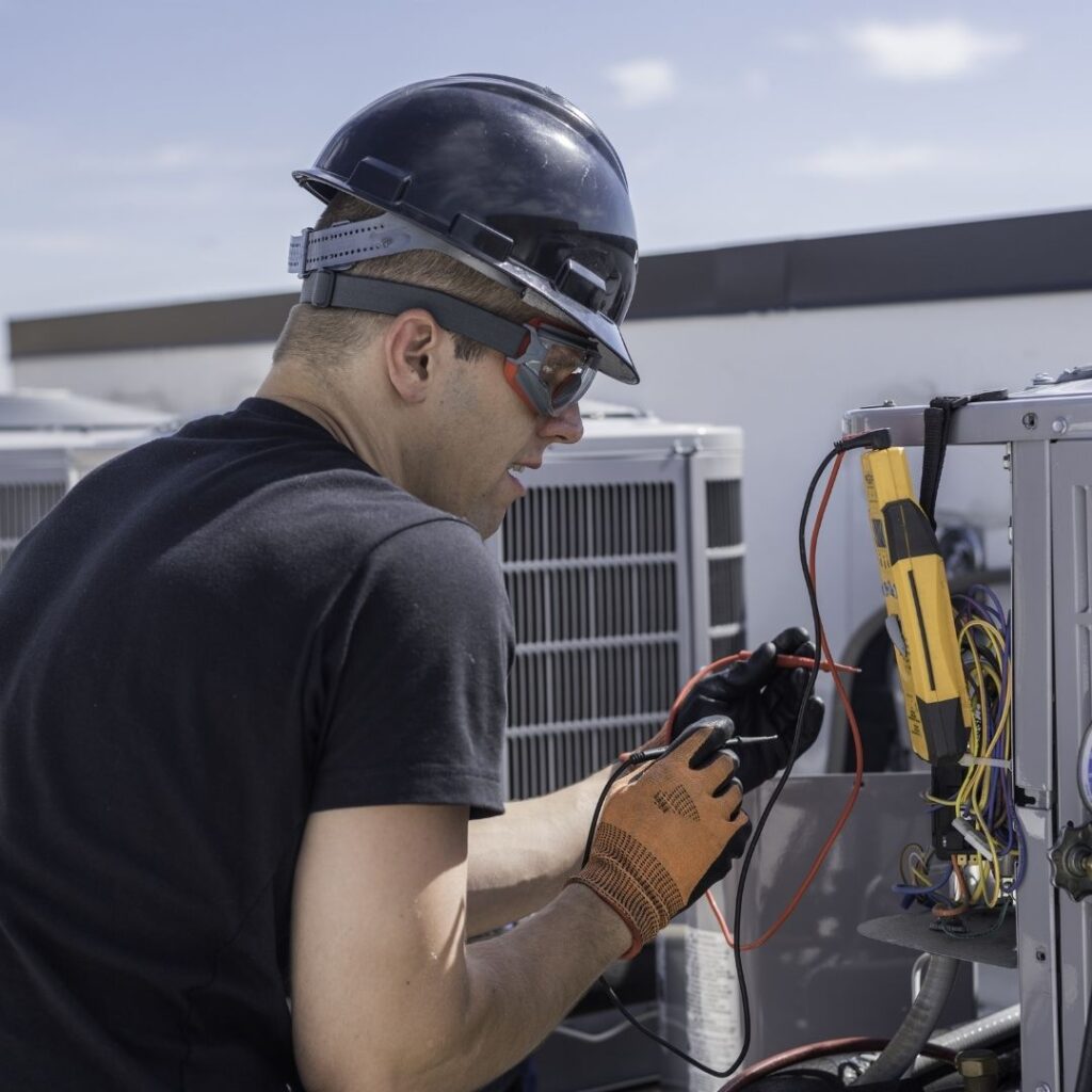 tech working on commercial AC units